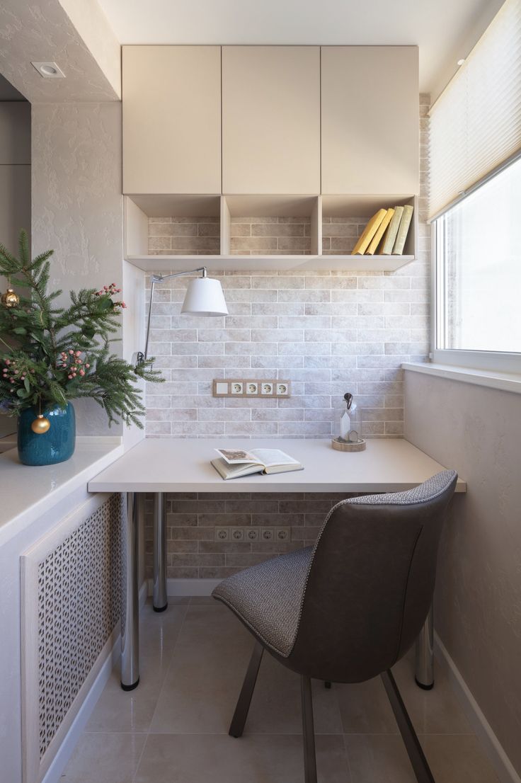 a white desk with a chair next to it and some books on the shelf behind it