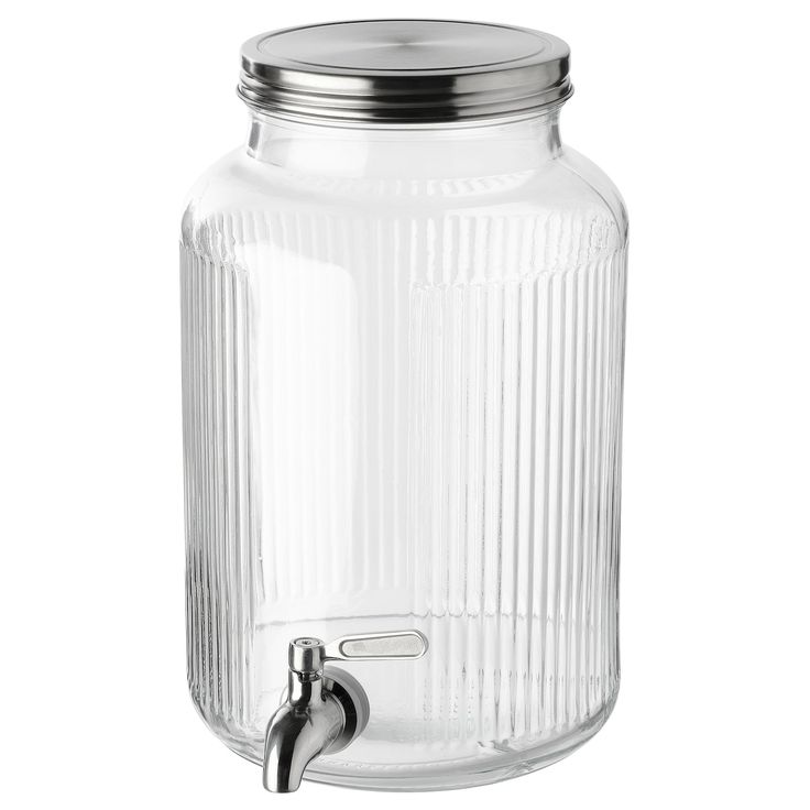 a glass jar with a metal lid and handle on the top, sitting on a white background