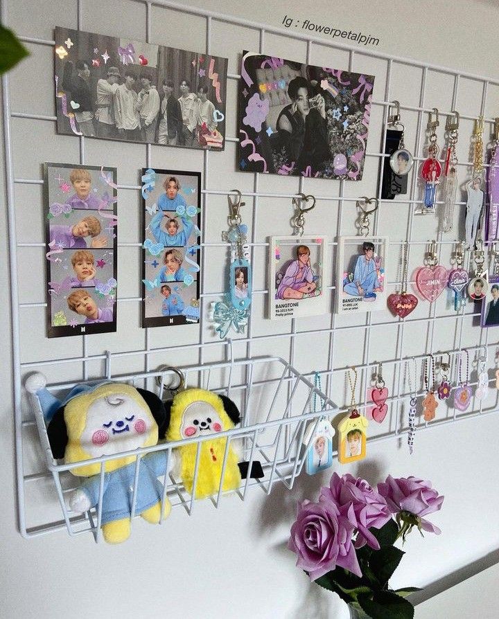 a bunch of pictures are hanging on the wall above a vase with flowers in it