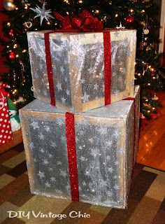 two wrapped presents sitting in front of a christmas tree