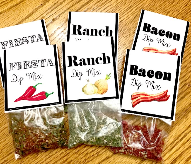 three bags of bacon dip mix sitting on top of a wooden table next to each other