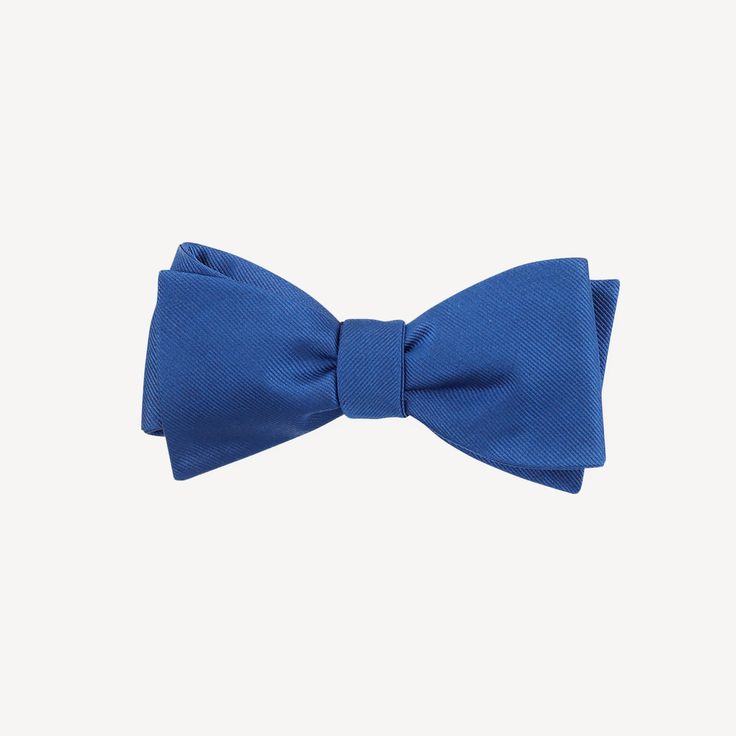 We've partnered with The Tie Bar to bring you this classic assortment of hand tied bowties in a variety of colors. Size is 2.5 in. wide x 58 in. long. Material: Handmade of 100% Silk Fabric Care: Imported, Dry-clean Only Detail: Hand Tied Classic Pre-tied Butterfly Knot Bow Tie, Blue Bow Tie With Butterfly Knot For Formal Events, Classic Pre-tied Decorative Bow, Blue Bow Ties For Business, Classic Blue Bow With Butterfly Knot, Blue Bow Tie For Business, Dapper Adjustable Blue Ties, Blue Adjustable Bow Tie And Suit Accessories, Blue Suit And Tie Accessories With Bow For Business