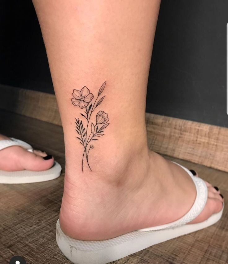 a small flower tattoo on the ankle