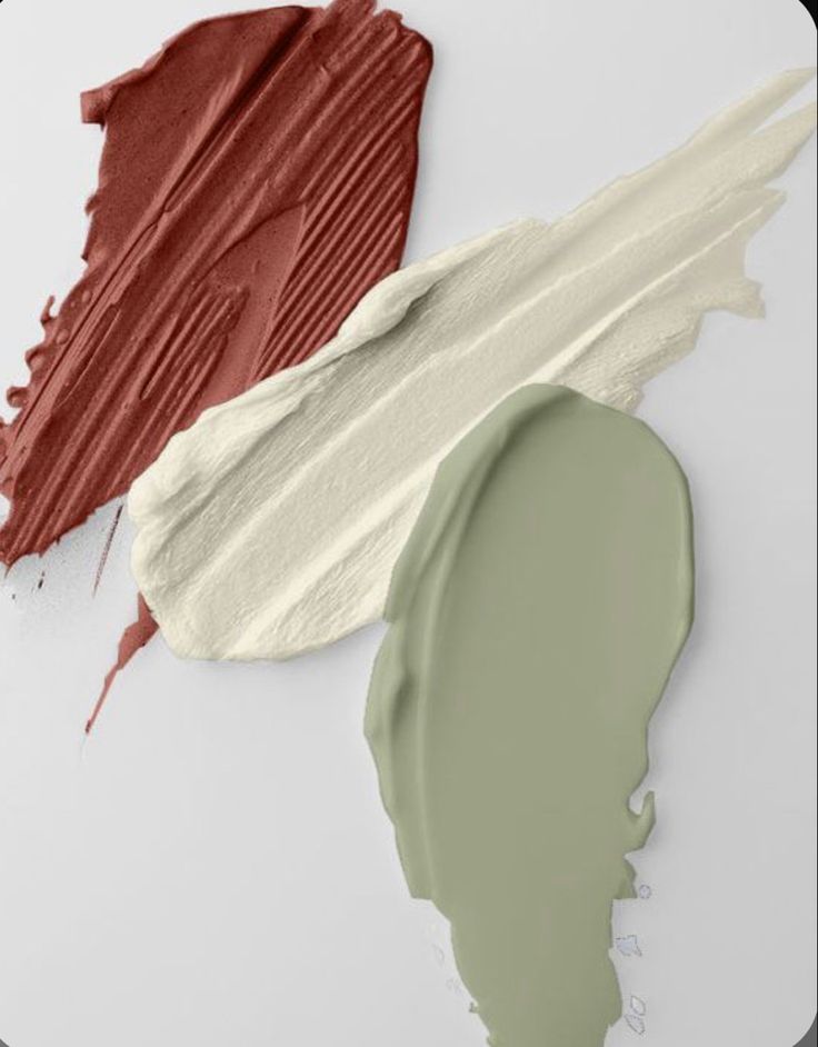 three different shades of paint next to each other on a white surface, one is green and the other is red