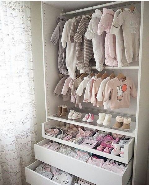 a baby's closet filled with lots of clothes and shoes on shelves next to a window