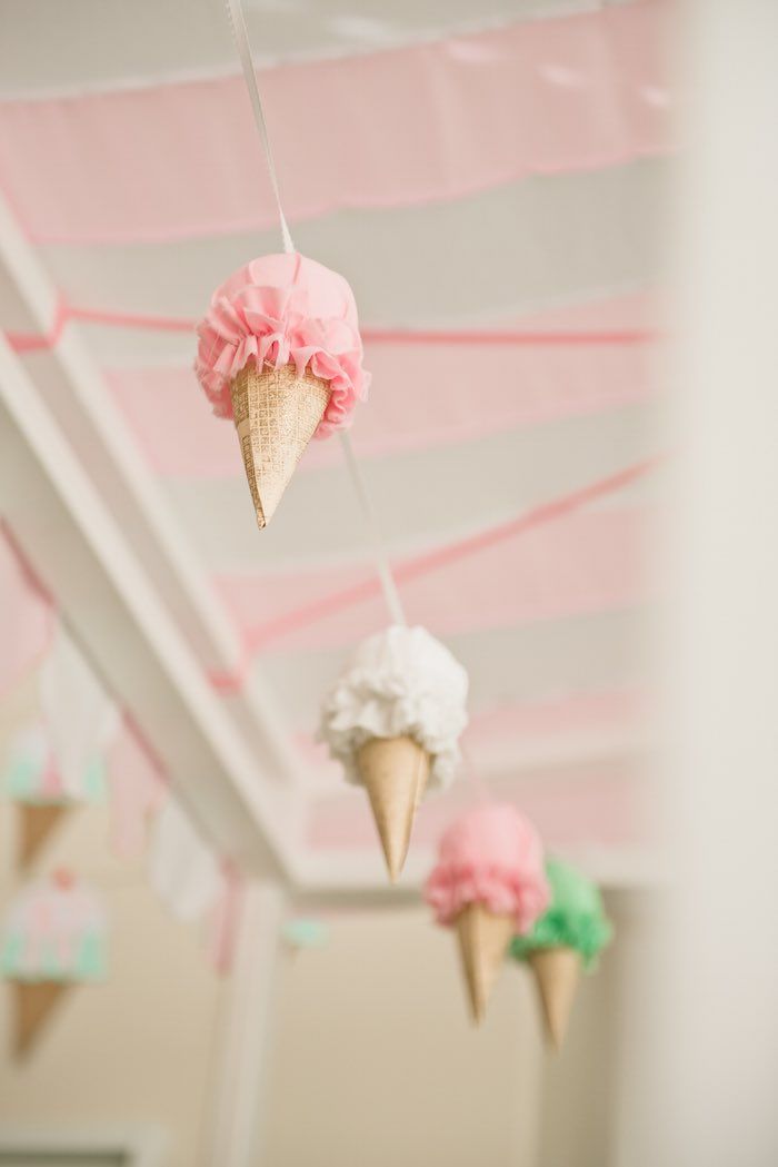 some ice cream cones hanging from a ceiling