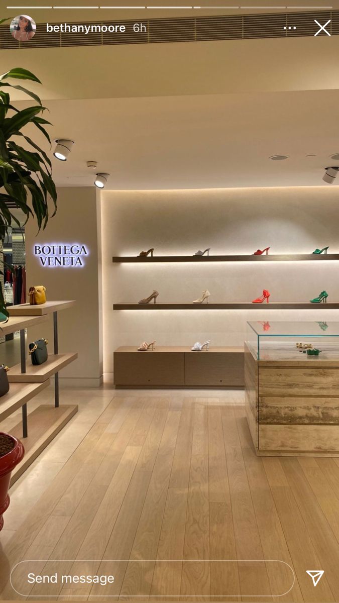 the inside of a shoe store with wooden floors