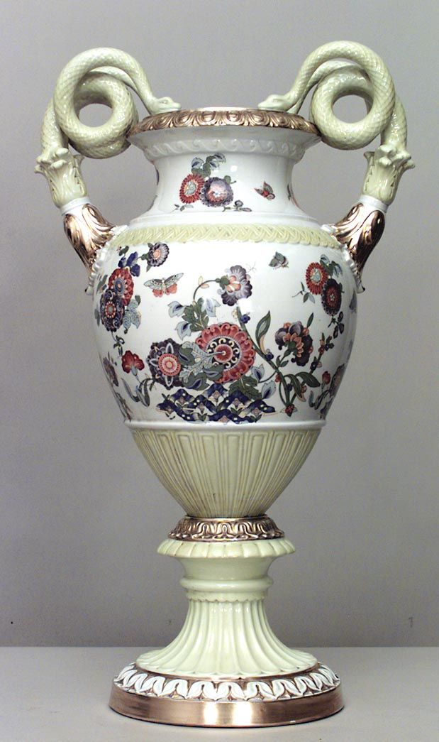 a white vase with floral designs on it