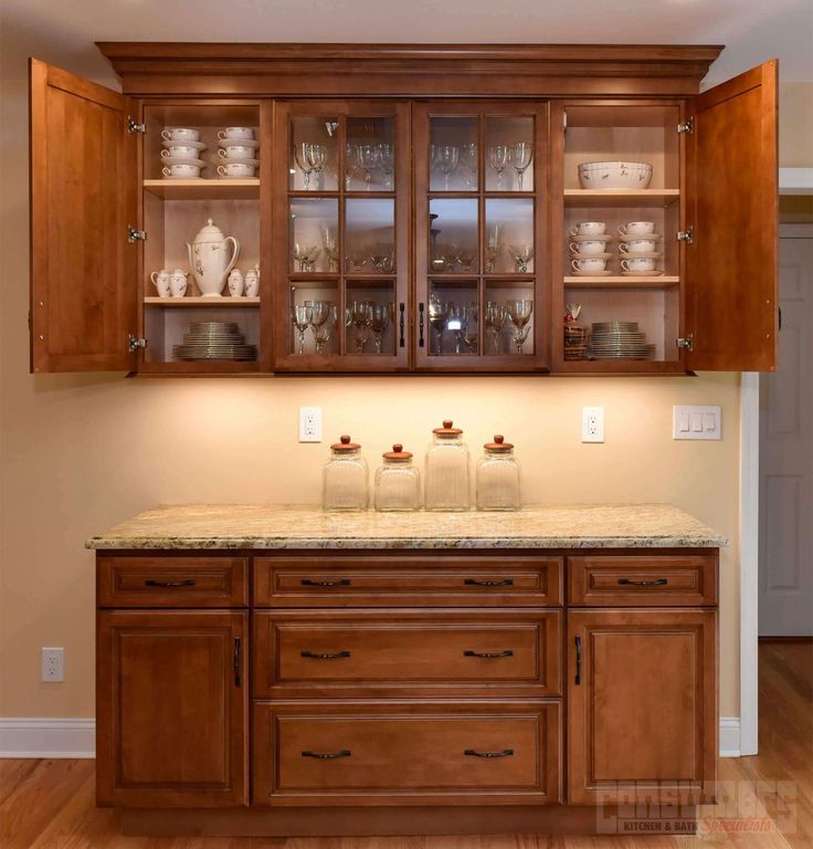 an empty kitchen with wooden cabinets and marble counter tops in the middle of the room