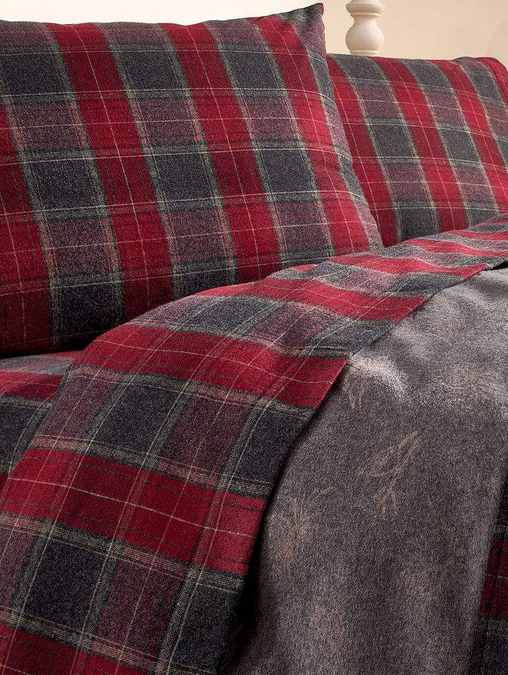 a red and black plaid comforter on a bed