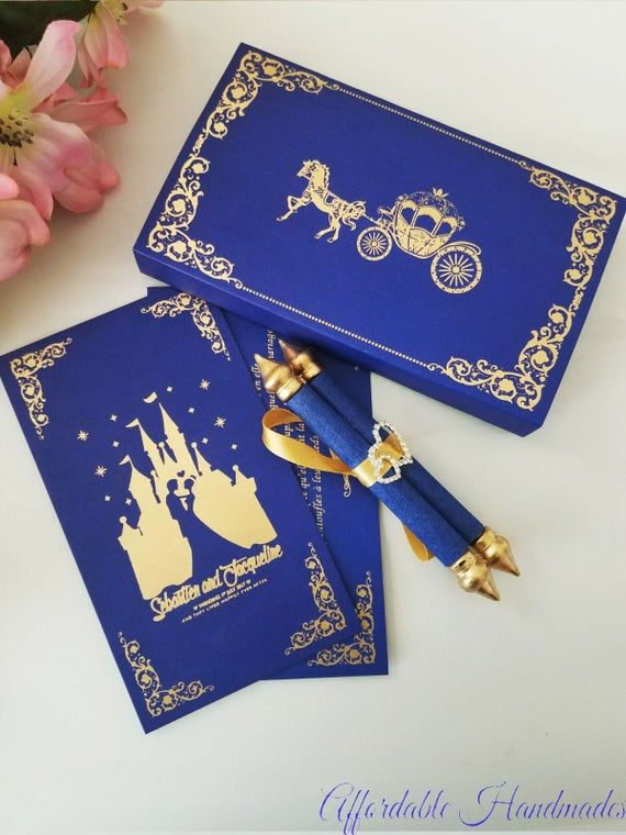 two blue cards with gold foil on them and a pen in front of the card