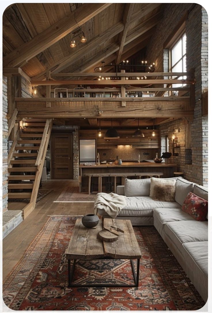 a living room filled with furniture next to a stair case on top of a wooden floor