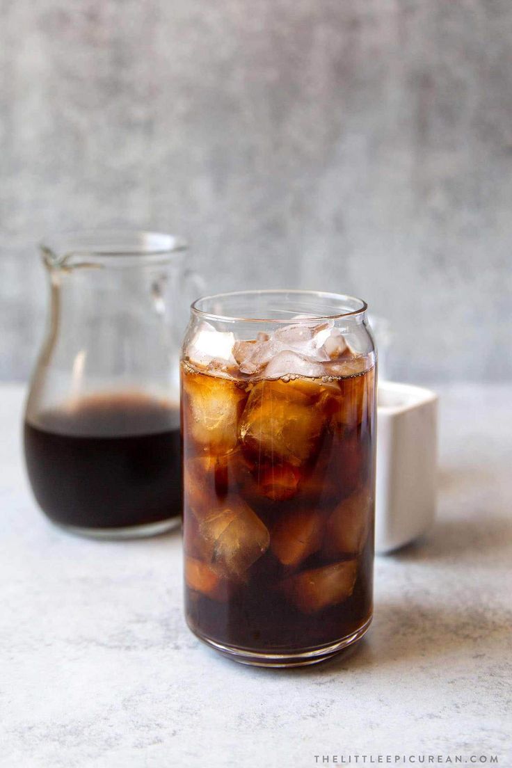 two glasses filled with iced coffee next to each other