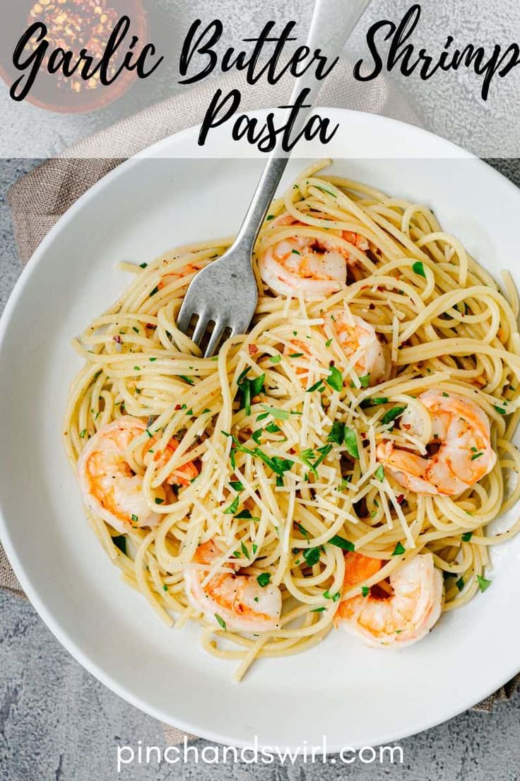 garlic butter shrimp pasta in a white bowl with a fork