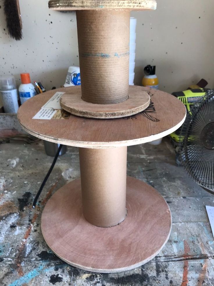 three tiered cat scratching tower in the process of being constructed with plywood and wood