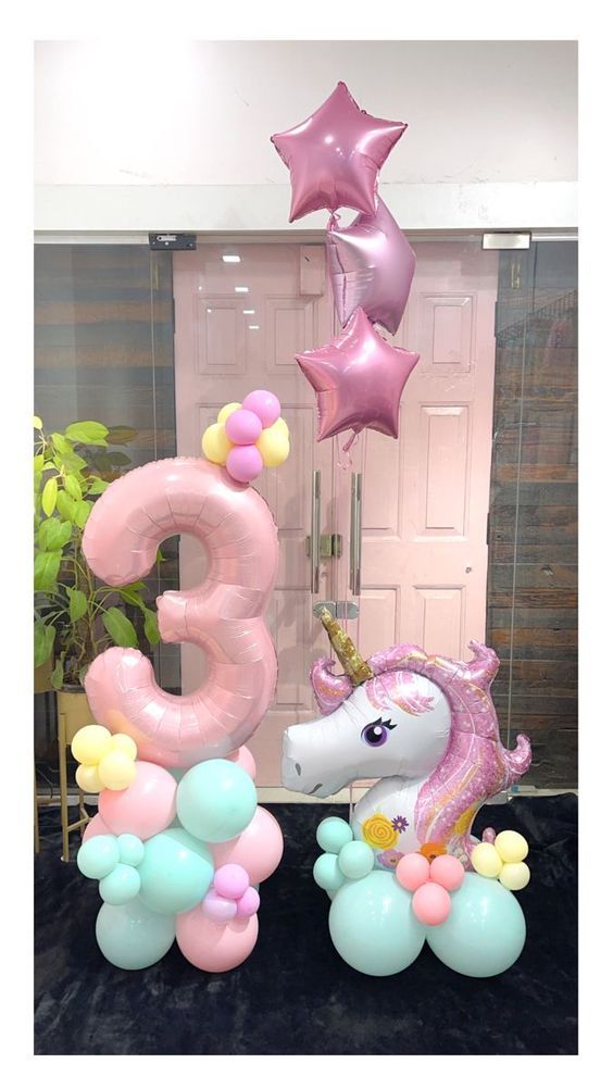 an image of balloons in the shape of unicorns and stars for a birthday party