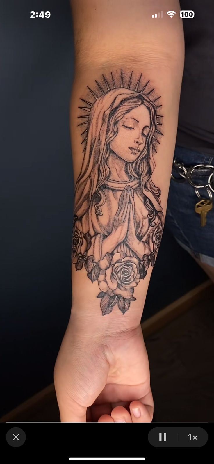 a woman's arm with a tattoo on it that has the image of mary