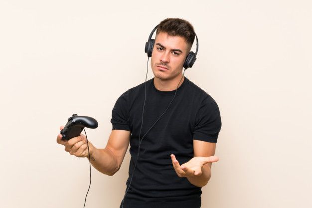 a young man wearing headphones holding a video game controller in one hand and pointing to the side