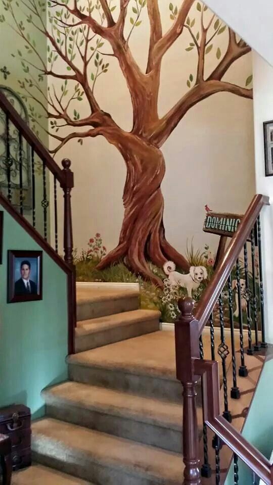 the staircase is painted with a tree mural