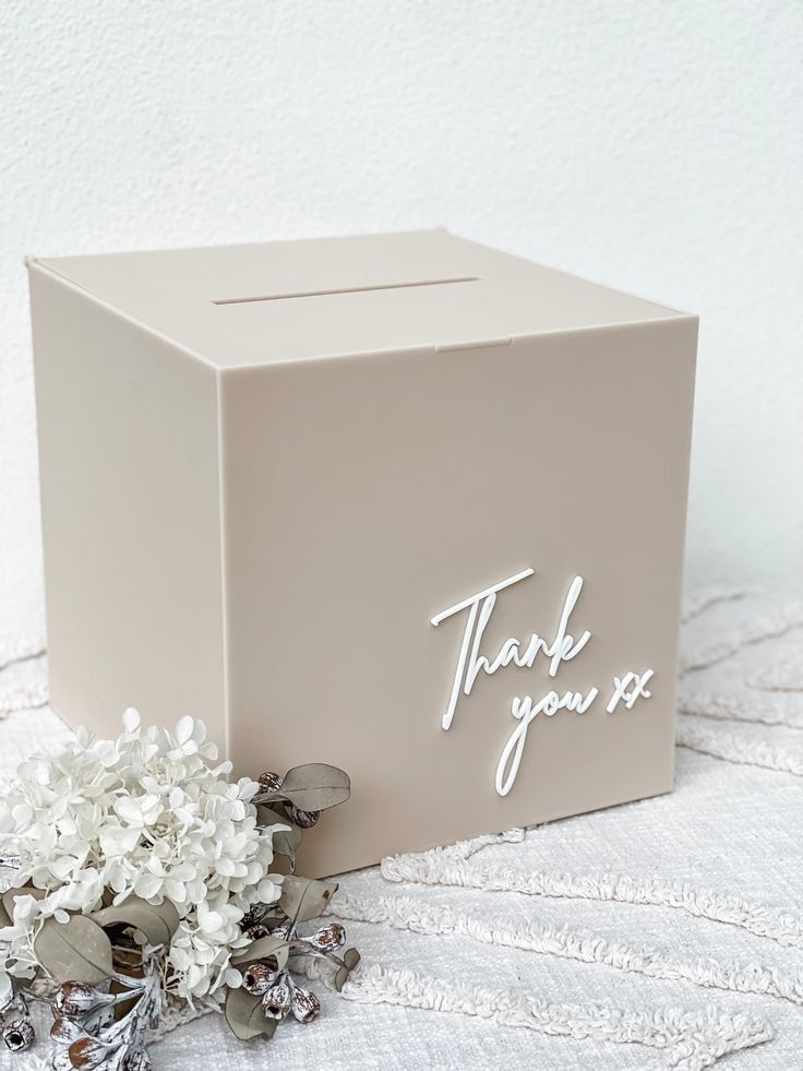 a thank you box with flowers on the side