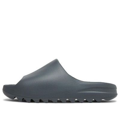 The adidas Yeezy Slide Slate Grey offers a lightweight and durable design. The color palette features a subtle yet versatile slate grey shade, making them suitable for various ensembles. With strategic cutouts and a breathable lining, these slides prioritize comfort. The outsole boasts a textured pattern for traction and stability. Perfect for casual wear or post-workout relaxation, these slides blend style and functionality seamlessly. The adidas Yeezy Slide Slate Grey is a collaborative creati Black Yeezy Slides, Yzy Slides, Yeezy Slides Outfit, Adidas Yeezy Slides, Grey Yeezy, Adidas Yeezy Slide, Slides Outfit, Grey Sandals, Yeezy Slides