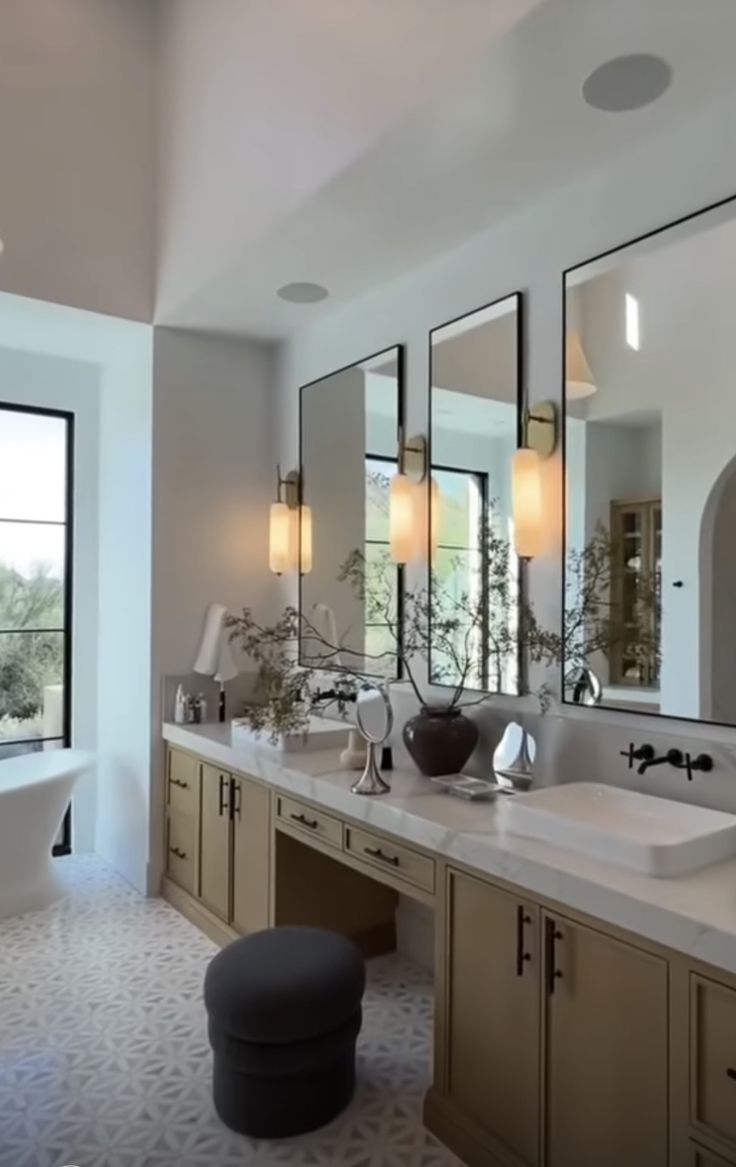 a large bathroom with double sinks and mirrors