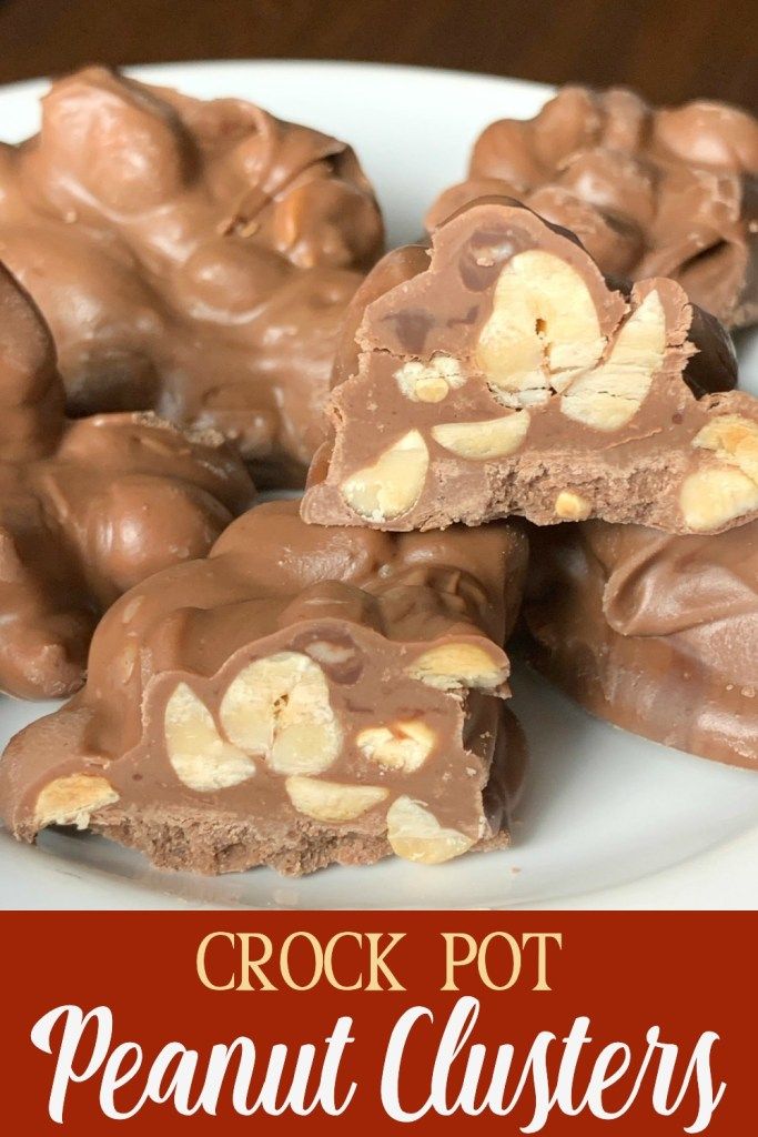 chocolate peanut clusters on a white plate with text overlay that reads crock pot peanut clusters