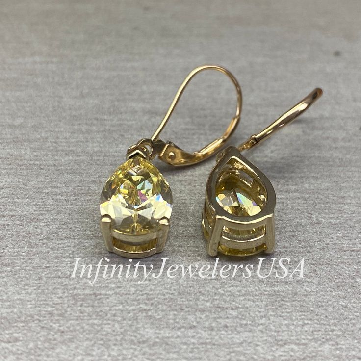 These earrings are pear shape simulated Canary yellow diamonds lever back earrings made with solid 14k yellow gold item #6843 -Approximate total carat weight: 6.00ctw -Center Stone Size: approx. 3.00ct each diamond equivalent -Gem Type: simulated diamond -Stone Shape: pear shape 12x8mm each -Stone Clarity: VVS1 -Stone Color: Canary Yellow -Metal Type and Purity: 14k yellow gold -Setting: 3 prong -Closure: lever back (earring backs are subject to change due to availability) -Country of Manufactur Gold Teardrop Earrings With Prong Setting, Gold Pear-shaped Sterling Silver Diamond Earrings, Gold Drop Diamond Earrings With Prong Setting, Gold Pear-shaped Diamond Earrings In Sterling Silver, Pear-shaped Gold Sterling Silver Diamond Earrings, Elegant Hypoallergenic Yellow Earrings, Classic Gold Teardrop Diamond Earrings, Gold Pear-shaped Diamond Earrings For Formal Occasions, Yellow Diamond Drop Earrings For Gift