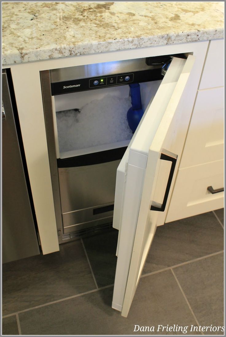 an open dishwasher door in the middle of a kitchen with tile flooring