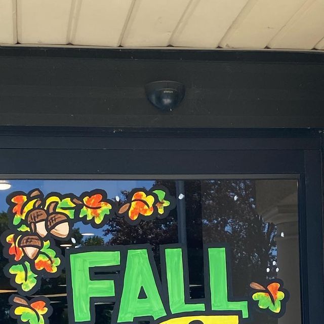 a window with the words fall sale painted on it's side and an image of a turkey