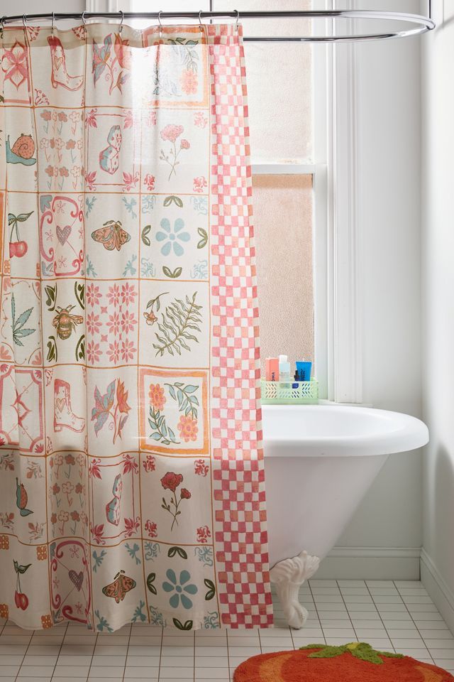 a bathroom with a shower curtain, rug and bathtub