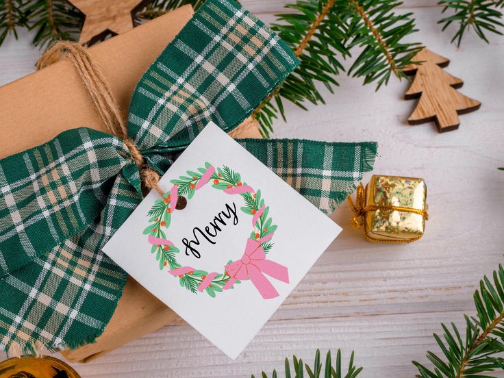 a christmas present wrapped in brown paper and tied with a green plaid ribbon, next to some pine branches