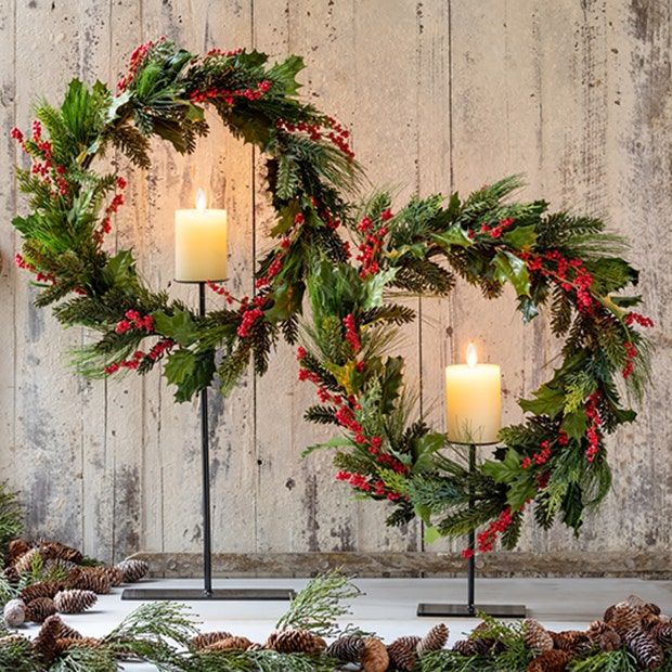 two wreaths with candles are sitting next to each other