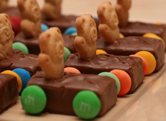 there are many pieces of chocolate with candy on it and some pretzels in the shape of elephants