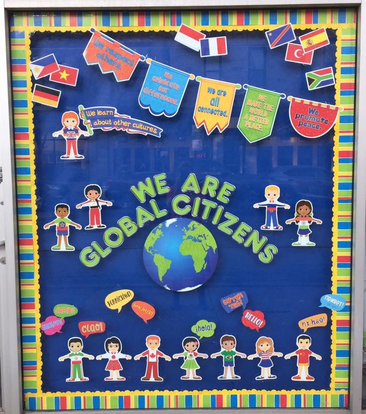 we are global citizens bulletin board displayed in front of a door with flags and stickers on it