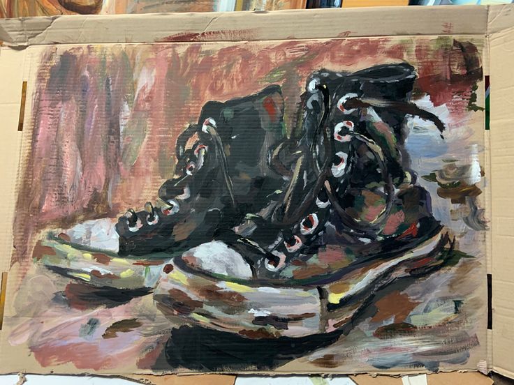 an oil painting of black shoes sitting on top of a cardboard box