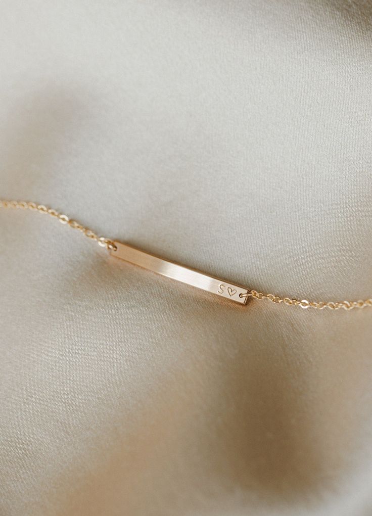 Versatile, practical and light-catching—this bracelet raises the bar. Personalize with names, dates, initials, coordinates or a short mantra (and wrap your wrist with what means most). Looking for something subtler? Try our teeny Basquiat Bar Bracelet (best for extra short, tiny inscriptions)! Looking for something bolder? Our Serra Bar Bracelet is our largest ID-type bracelet. Minimalist Initials Bracelet For Anniversary, Dainty Engraved Bracelets For Everyday Wear, Dainty Engraved Bracelets For Everyday, Dainty Engraved Bracelet For Everyday Wear, Dainty Everyday Engraved Bracelets, Delicate Personalized Name Bracelet, 14k Gold Nameplate Bracelet For Everyday, Rose Gold Bracelets With Initials For Everyday, Everyday 14k Gold Nameplate Bracelet