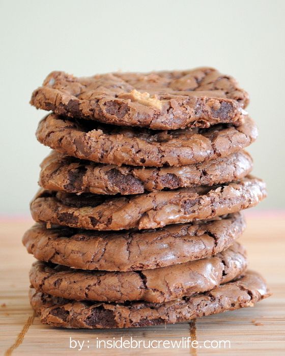 a stack of chocolate cookies sitting on top of a wooden table