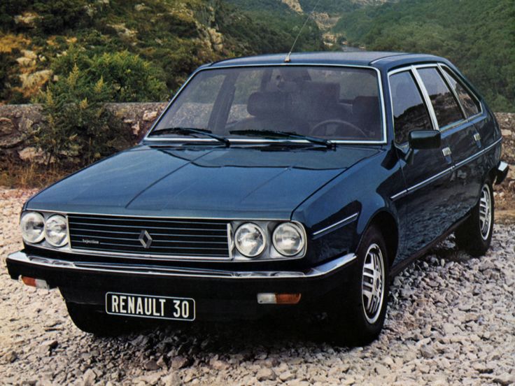 a black car parked on top of a rocky road