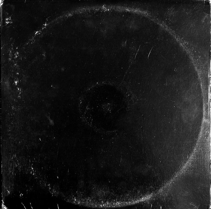 an old black and white photo of a circular object in the middle of it's frame