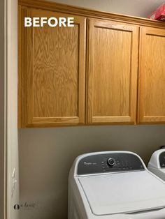 a washer and dryer in a room with wooden cabinets above the washer