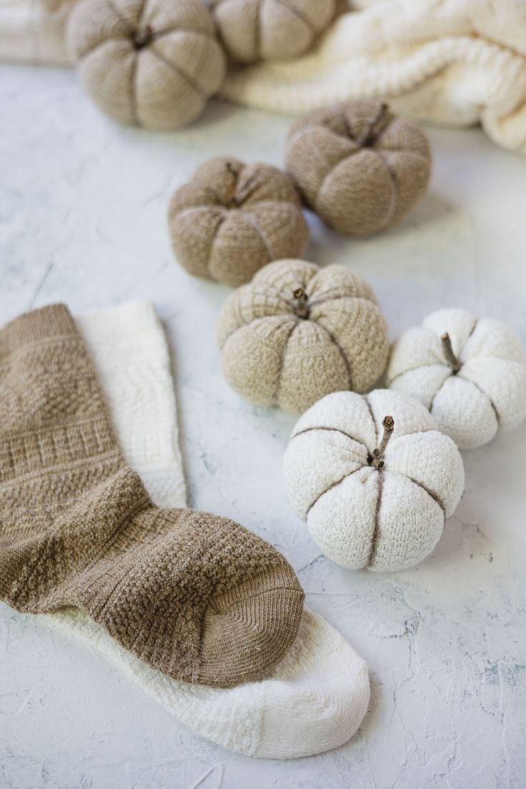 several small pumpkins and socks on a table