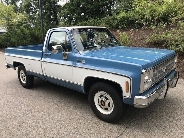 a blue and white truck parked in a parking lot