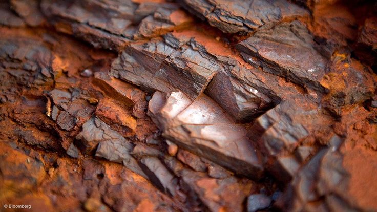 closeup of rocks and rust on the surface of an iron - plated rock