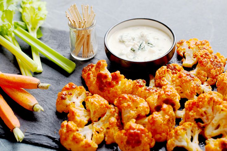 some cauliflower and dip on a table