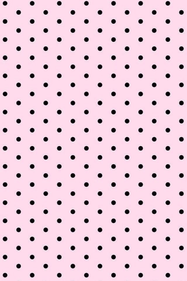 a pink background with black polka dots