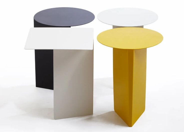 three different colored tables sitting next to each other on a white surface in front of a white background