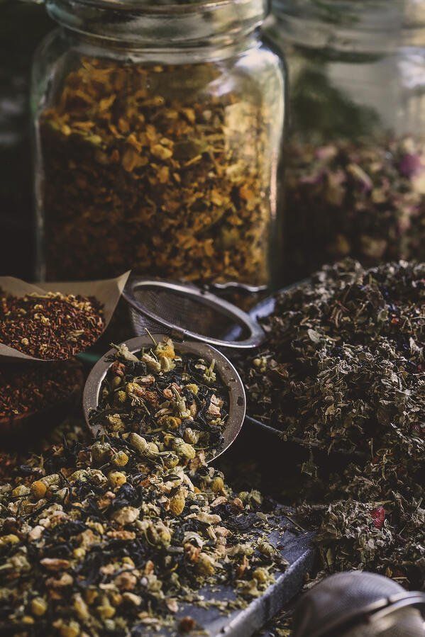 several jars filled with different types of herbs