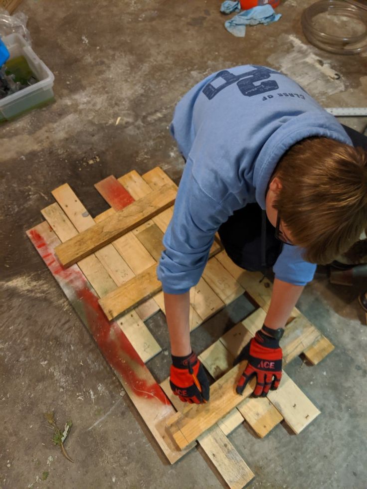 a person working on some wood in a room