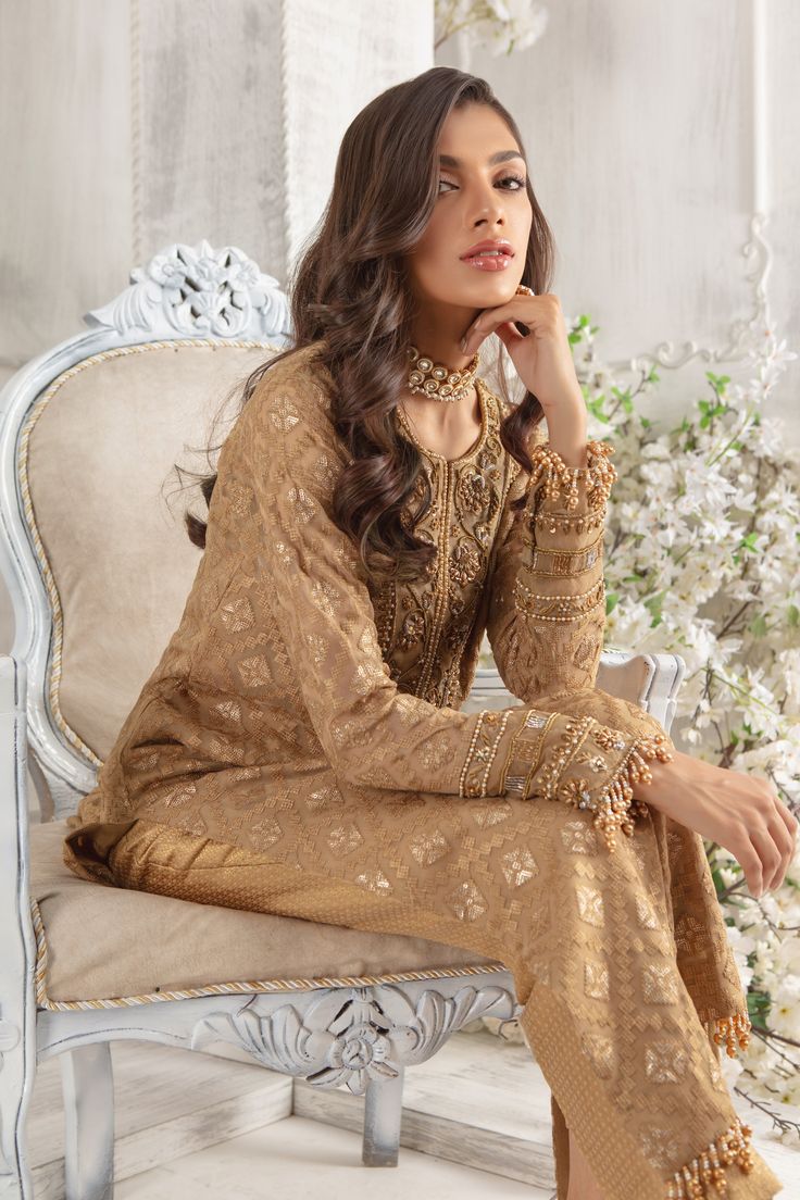 Crafted on luscious Pure chiffon canvas, this A-line shirt features embellished neckline and sleeves with dabka, pearls, beads and tila work. This exclusively curated shirt is further highlighted with laboriously detailed tasseled border on hem and sleeves to add glamour and oomph. Off set with pure chiffon sequin and bead embellished dupatta with beautifully composed border and Gold jamawar straight pant.Shirt Fabric: Pure Embroidered chiffonShirt Length: 48” (max length)Pant Fabric: JamawarDup Designer Outfit, Embellished Neckline, Pure Chiffon, Embroidered Chiffon, Pakistani Designers, Chiffon Shirt, Shirt Fabric, Pant Shirt, Shirt And Pants